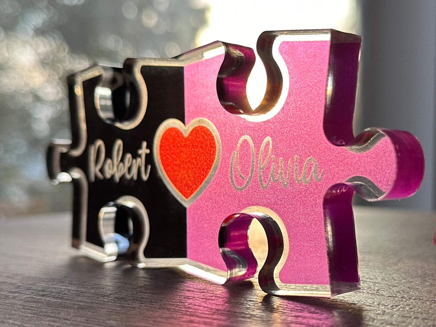 Personalized hand-cut puzzle piece with names Robert and Oluna and a heart design, showcasing a unique handmade gift.